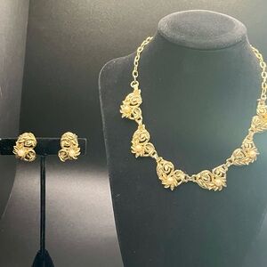 Signed Delsa gold-tone leaf and faux pearl necklace and earring set